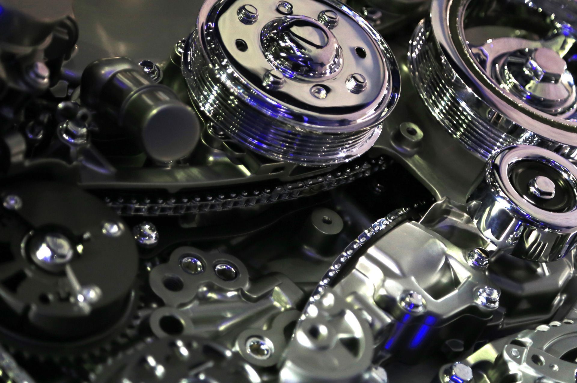 A close up of a car engine with gears and pulleys