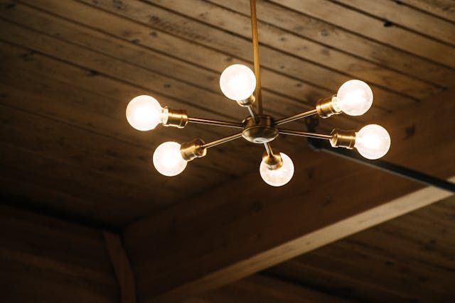 A chandelier with six light bulbs hanging from the ceiling