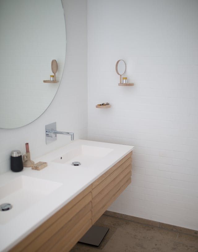 A bathroom with two sinks and a mirror.