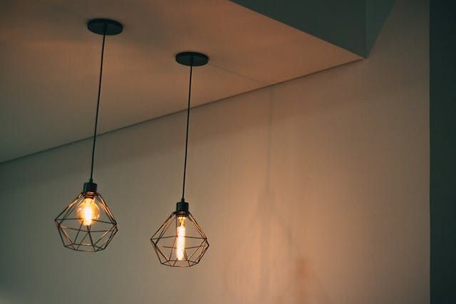 Two pendant lights are hanging from the ceiling in a room.