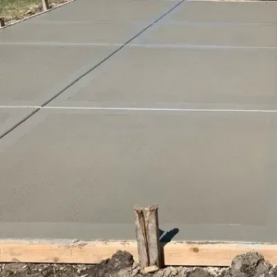 Newly completed broom-finished concrete patio in Taita.