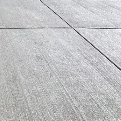 Newly cured broom-finished concrete driveway in Maori Bank.