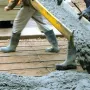 Concrete contractor pouring a driveway in Petone, Lower Hutt, demonstrating our Hutt Valley services process.