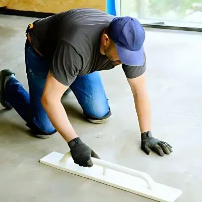 Concrete contractor troweling interior cement floor finishes, professional installation, Totara Park, Upper Hutt.