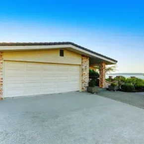 New concrete driveway leading to a residential garage door in Days Bay overlooking the harbour.