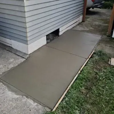 Side view of newly completed concrete path slab installation in Wainuiomata.