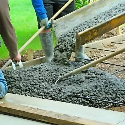 Concrete workers pouring a driveway in Hutt Valley, Wellington, illustrating our competitive price per square meter.