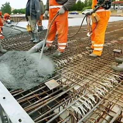 Team pouring concrete over steel mesh for commercial project in Petone, Lower Hutt.
