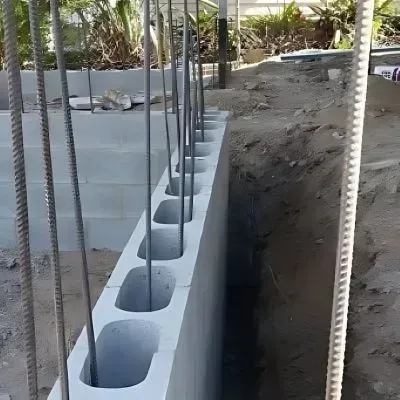 A concrete retaining wall with steel reinforcement was applied to a project in Normandale.