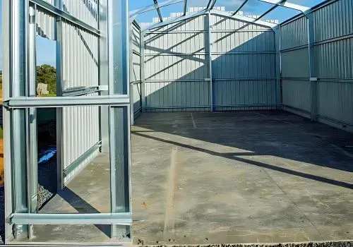 Concrete shed slab placed for building project in Elderslea, Upper Hutt. Shed construction has been half completed.