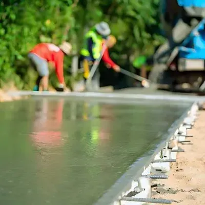Concrete contractors pouring and leveling cement foundation in Waiwhetu, Lower Hutt.