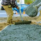 Concrete truck pouring concrete onto the driveway in Raroa Road, Hutt Central.