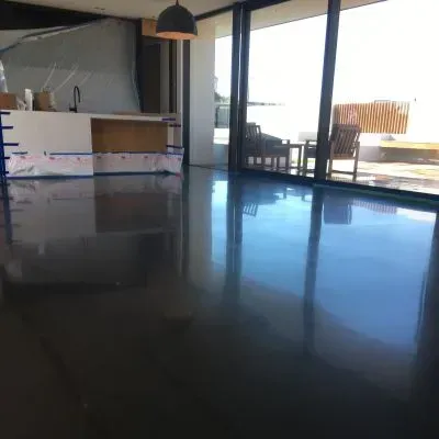 High-gloss cream polished concrete floor in a modern kitchen-living space, Silverstream, Upper Hutt.