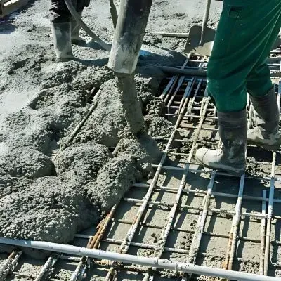 Crew pumping concrete onto a new parking lot site over mesh, showcasing professional construction work in Hutt Central.