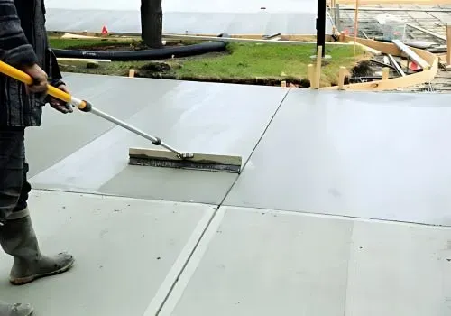 Driveway contractors brushing finished concrete on a large construction project in Hutt City.