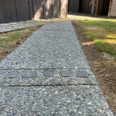 Close-up rear view of exposed aggregate concrete path in Eastbourne, detailing the decorative finish.