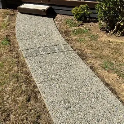 Angled view of exposed aggregate concrete walkway in Eastbourne, Lower Hutt, showcasing craftsmanship.