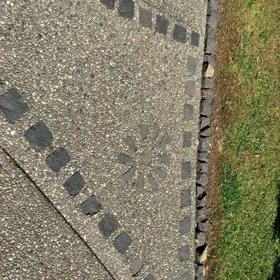 Decorative exposed aggregate concrete walkway in Eastbourne, installed by our experienced contractors.