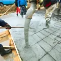 Team pouring and leveling a large foundation, demonstrating compliance with council processes.