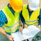 One of our concrete team leaders discussing the building consent with the Hutt City Council member over blueprint.