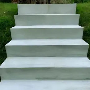 Concrete stairs on a grass bank leading to a home in Maungaraki.