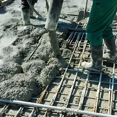 Contractors installing reinforced concrete with machinery in the Hutt Valley, Wellington.