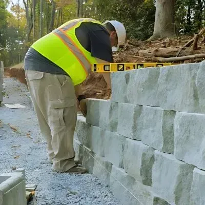 Retaining wall specialist constructing a block wall near the forest backyard in Maoribank.