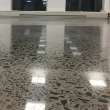 Salt-and-pepper polished concrete with medium aggregate exposure in a commercial space, Trentham.