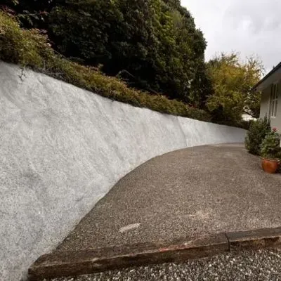 Sprayed concrete retaining wall, 20 metres long, 3 metres high. Finished showcasing wide angle, Normadale, Lower Hutt.