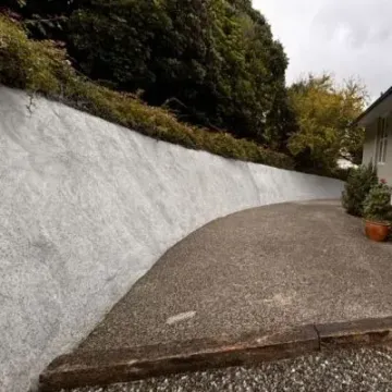 Sprayed concrete retaining wall, 20 metres long, 3 metres high. Finished showcasing wide angle, Normadale, Lower Hutt.