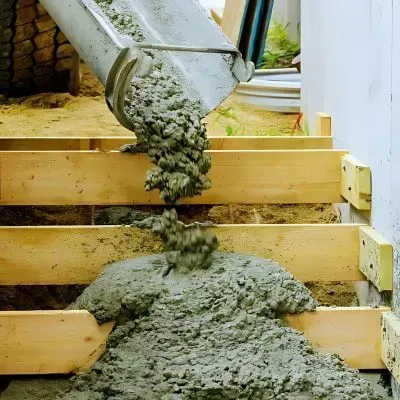 Stair builders are pouring concrete into stair boxes outside a residential property in Wallaceville, Upper Hutt.