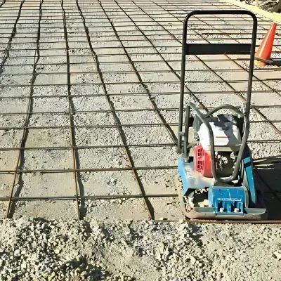 Steel mesh reinforcement and soil compactor on driveway construction site in Park Avenue, Lower Hutt.