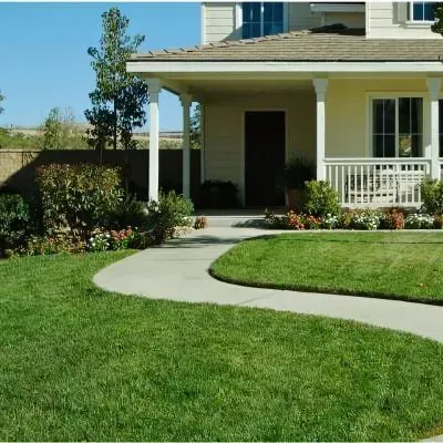Winding concrete path leading to the front porch and door of a residential home in Heretaunga.