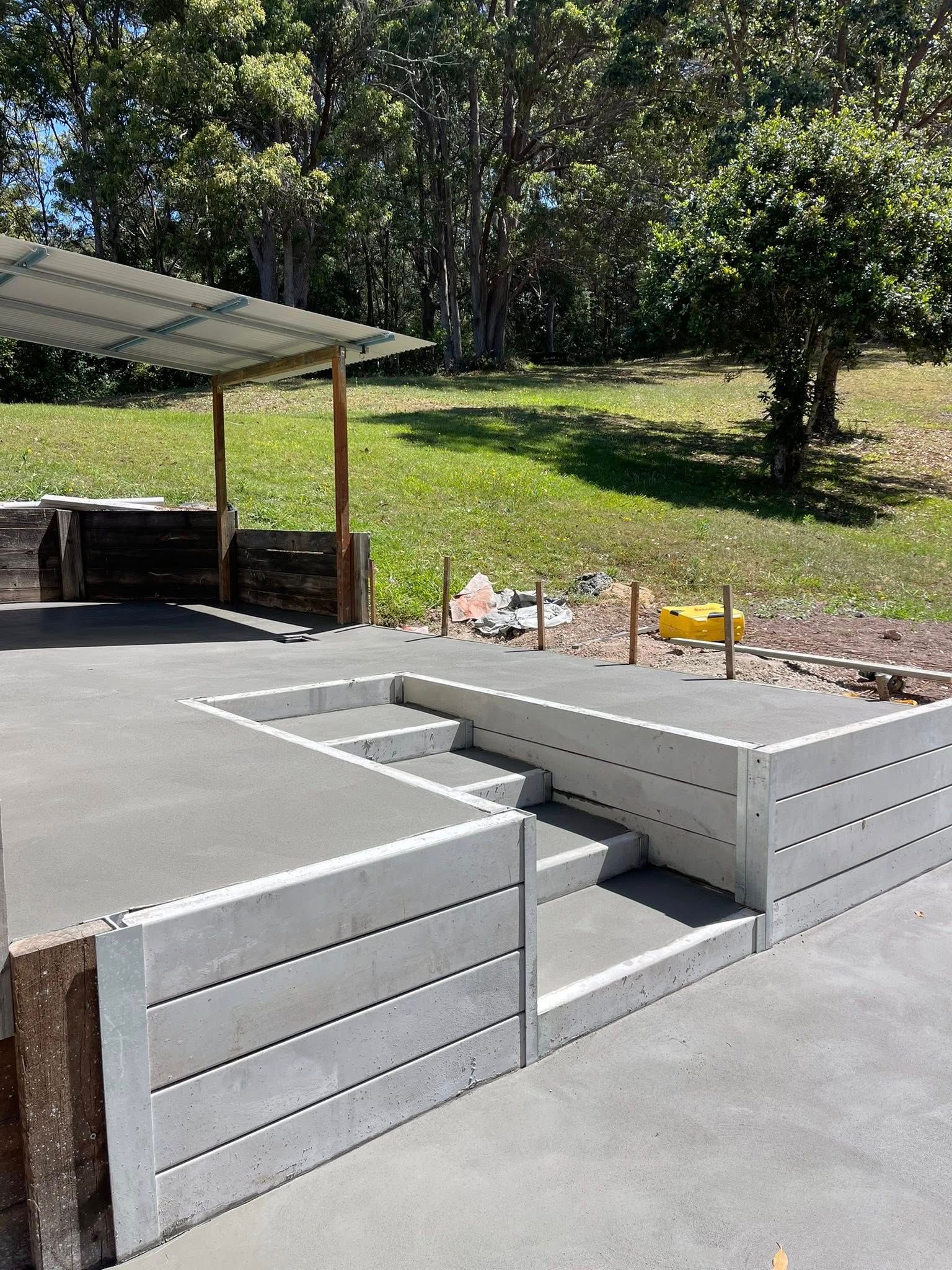 Concrete Patio With Retaining Walls and Steps Leading Up to an Elevated Area — All Concrete Creations in Kingscliff, NSW