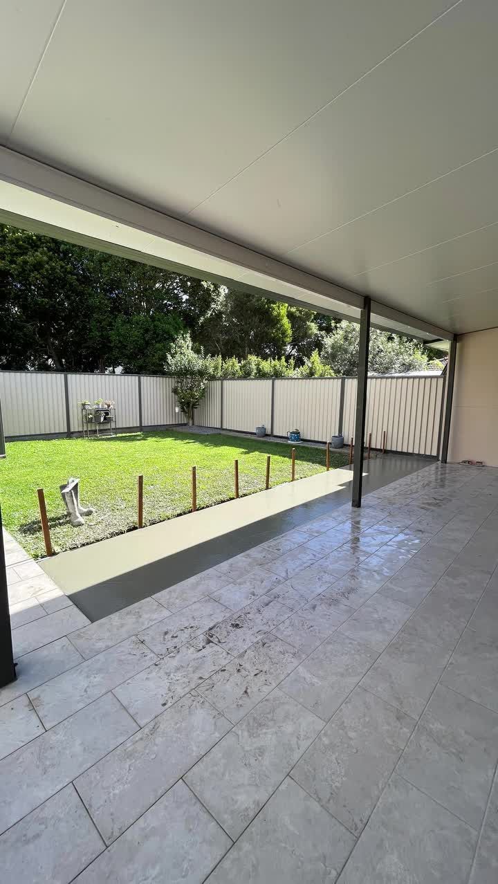 Patio With Gray Tiled Floor, Leading to a Grassy Yard — All Concrete Creations in Kingscliff, NSW