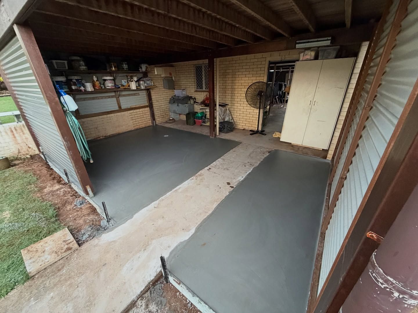 Freshly Poured Concrete Patio Under a Corrugated Metal Roof — All Concrete Creations in Kingscliff, NSW