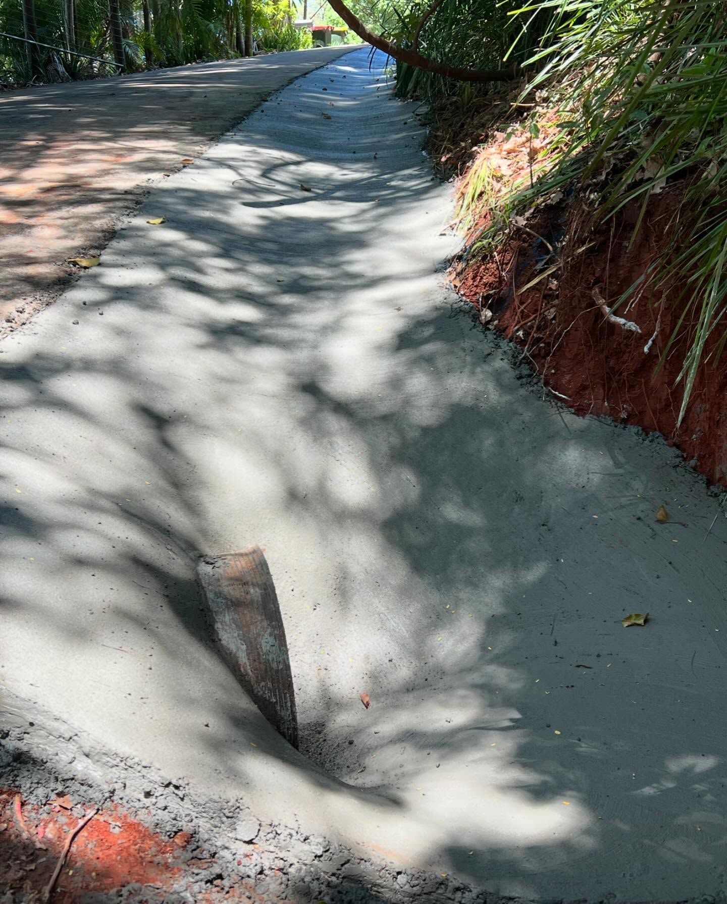 Freshly Poured Concrete Drainage Channel Next to a Dirt Embankment — All Concrete Creations in Kingscliff, NSW