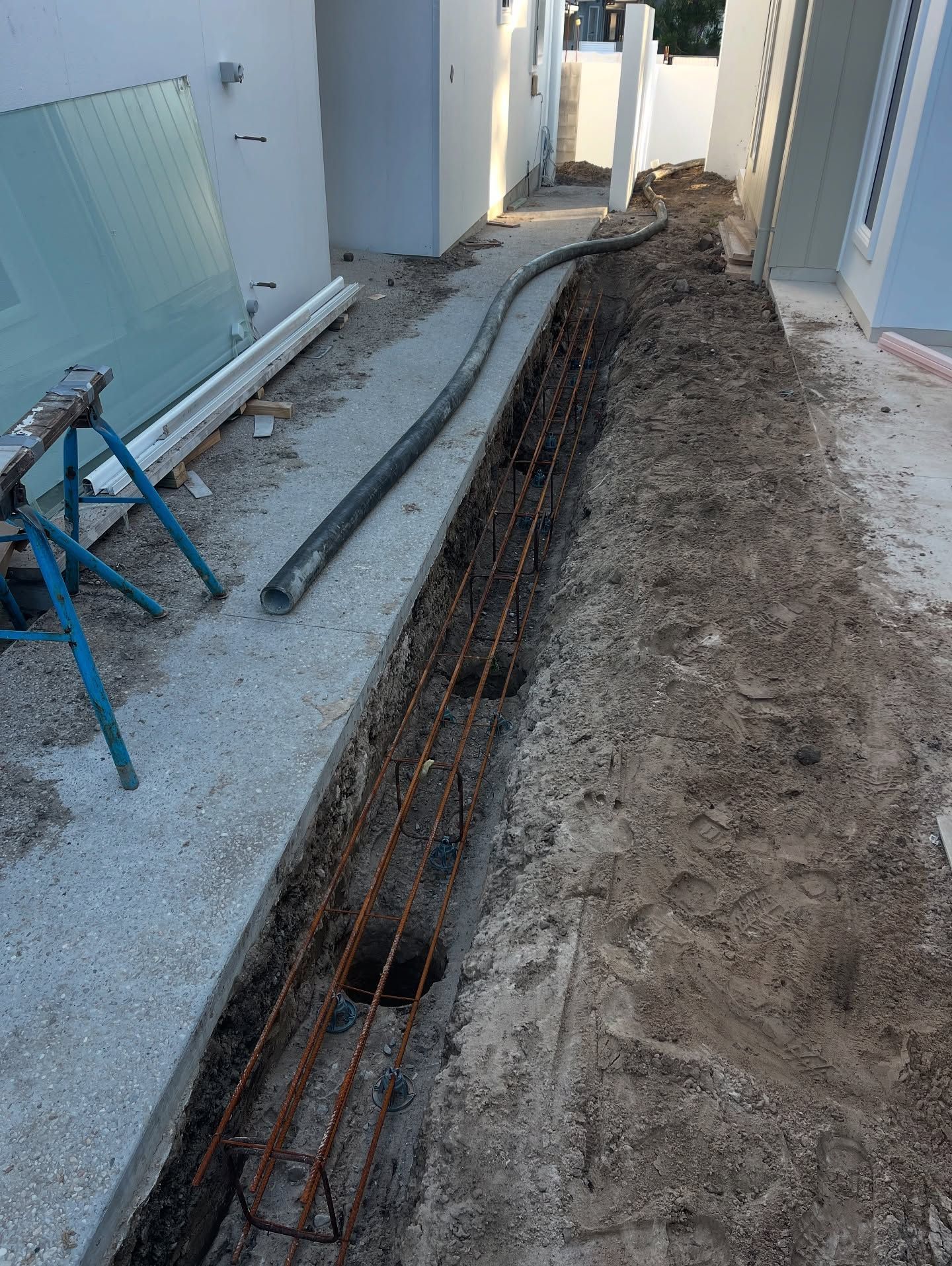 A Narrow Trench With Exposed Rebar, Concrete Path on the Left — All Concrete Creations in Kingscliff, NSW