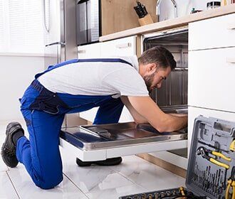 Appliance — Repairman Repairing Dishwasher in Wooster, OH