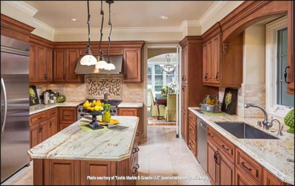 Kitchen with wood cabinets, island, and granite countertops. Stainless steel appliances and sink.