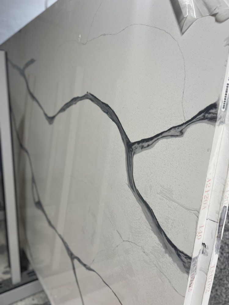 Large slab of light gray material with dark gray veining.