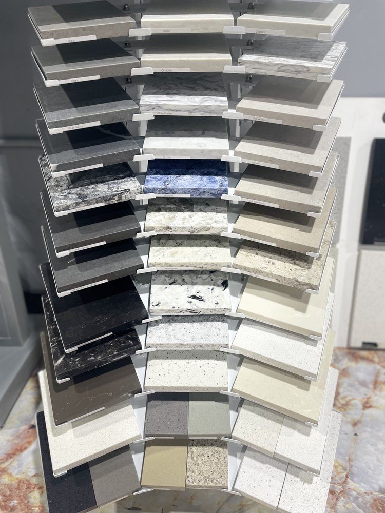 Samples of countertop materials displayed on a rotating rack, featuring various colors and textures.