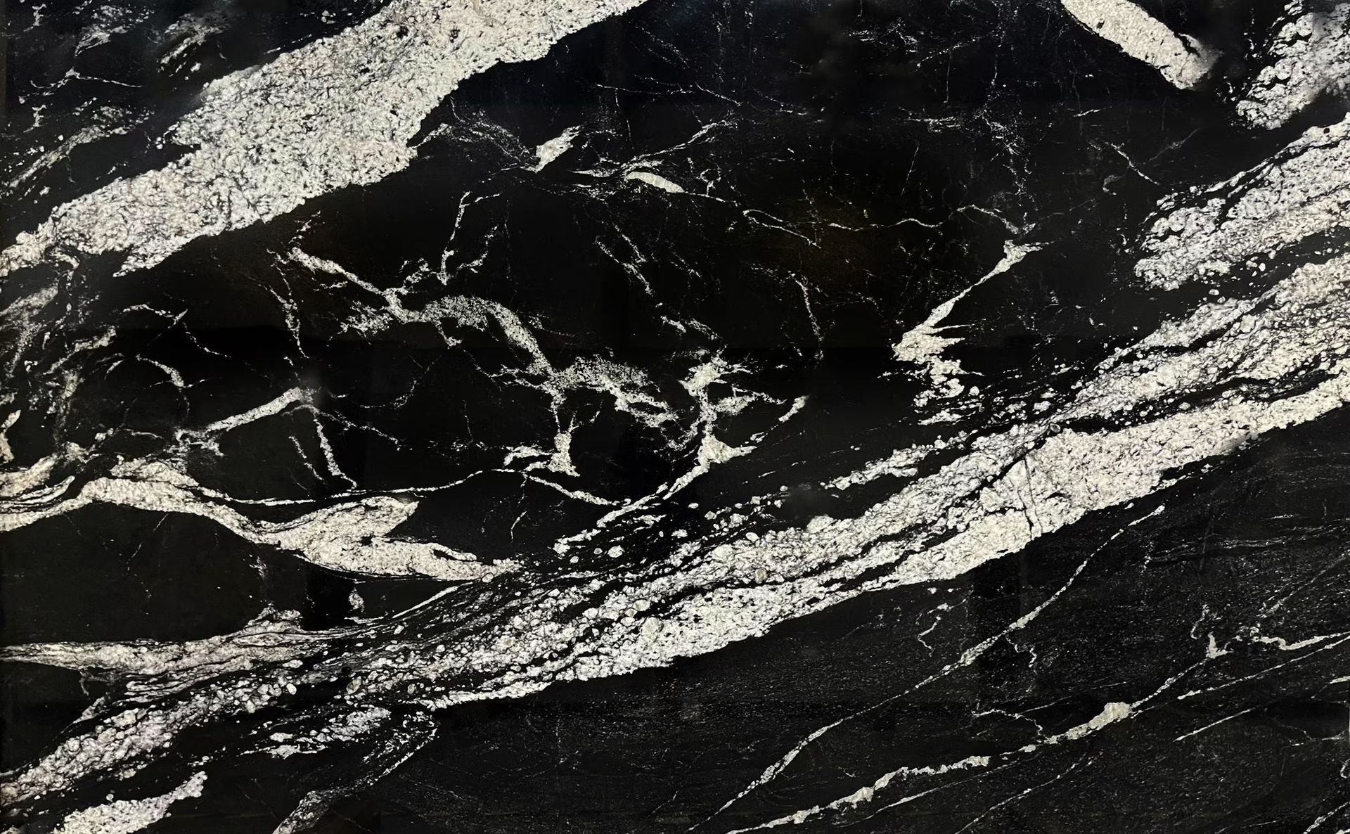 Black granite with white veins and patterns.