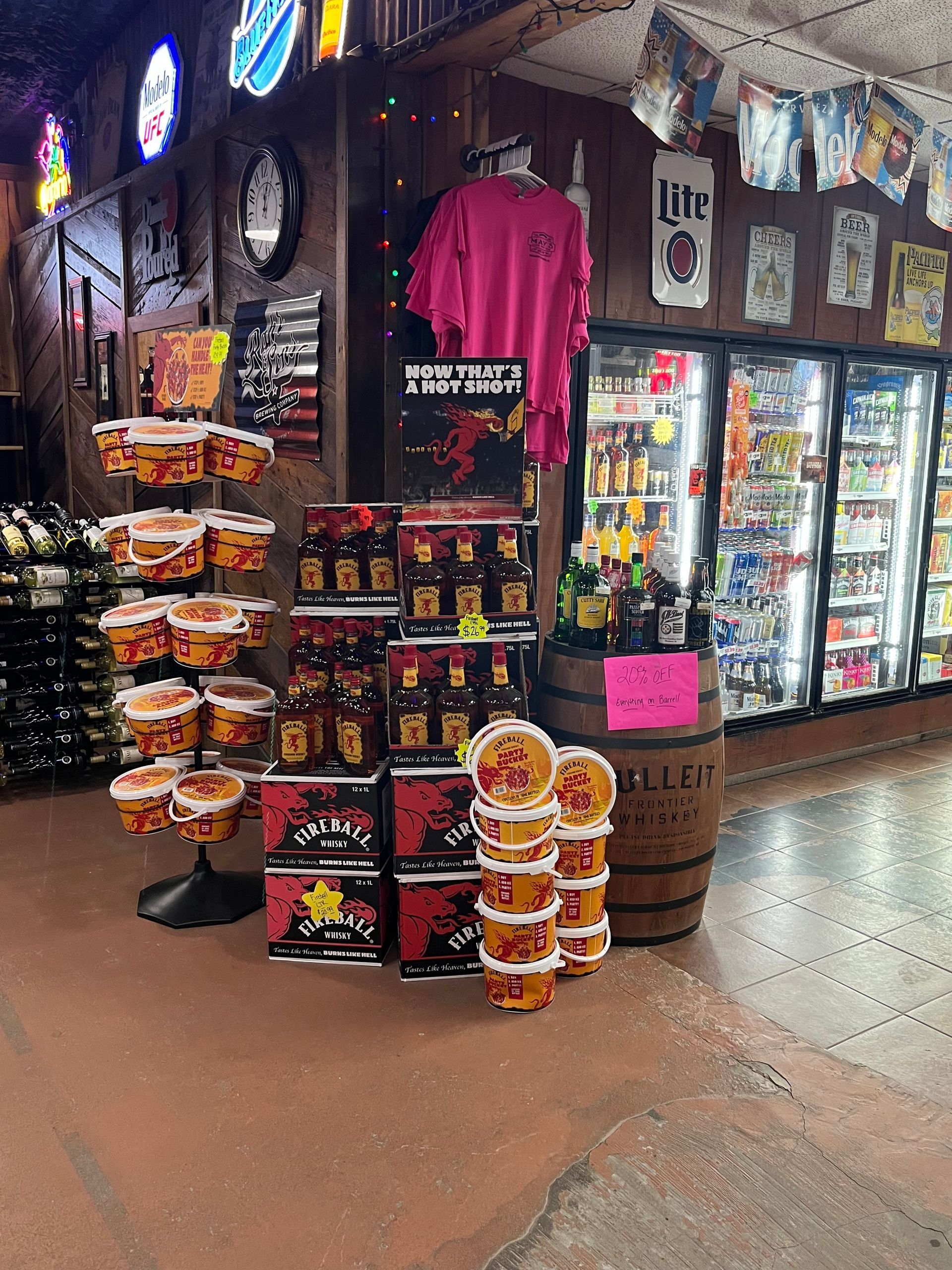 Inside a store, a product display of various spicy honey products, and beverages.
