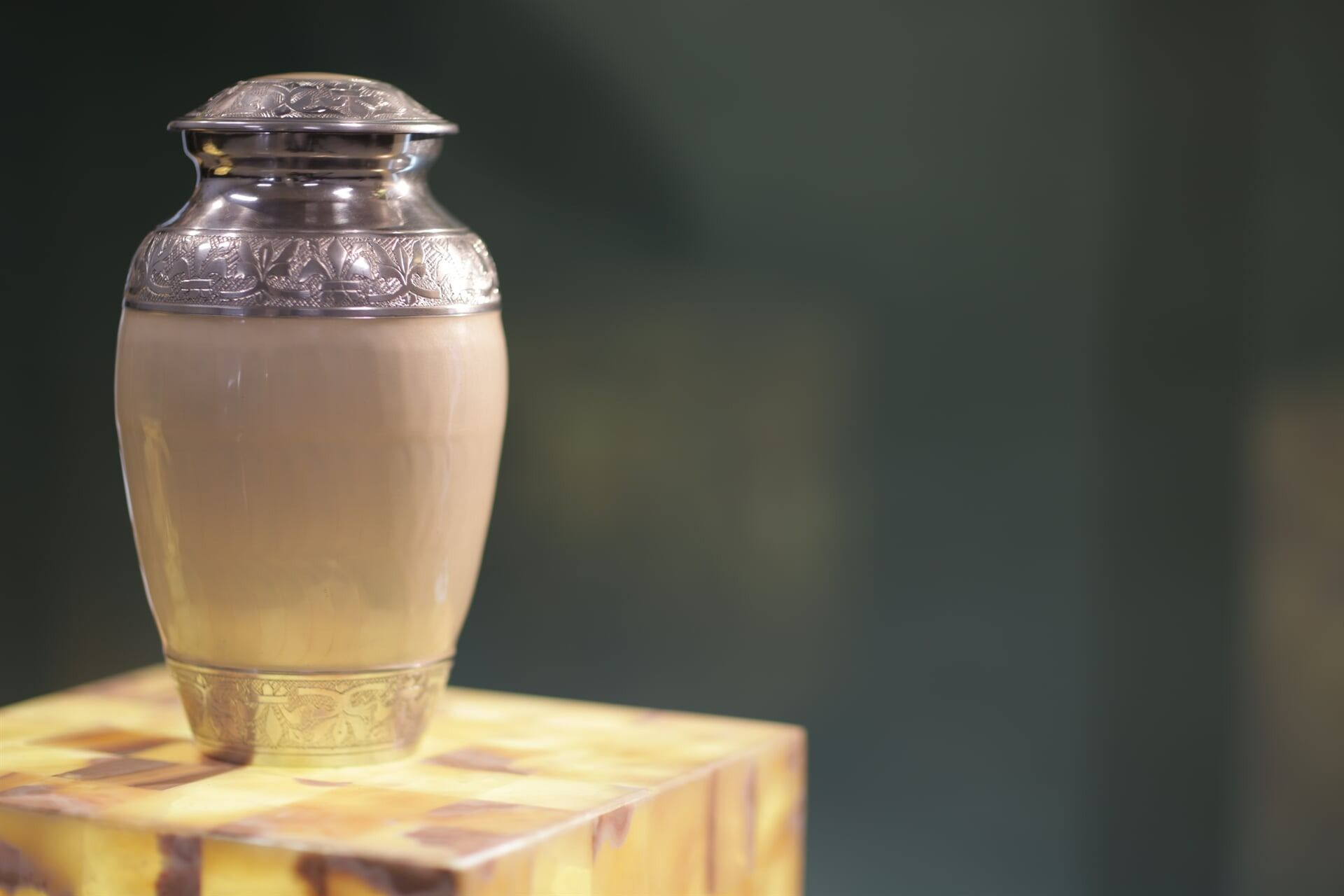 Silver and Beige Cremation Urn With Decorative Detailing — Finlayson & McKenzie Funeral Directors in Rockhampton City, QLD