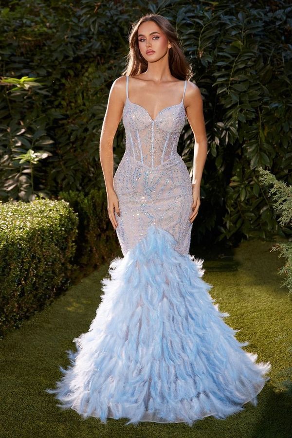 A woman is wearing a light blue feathered mermaid dress.