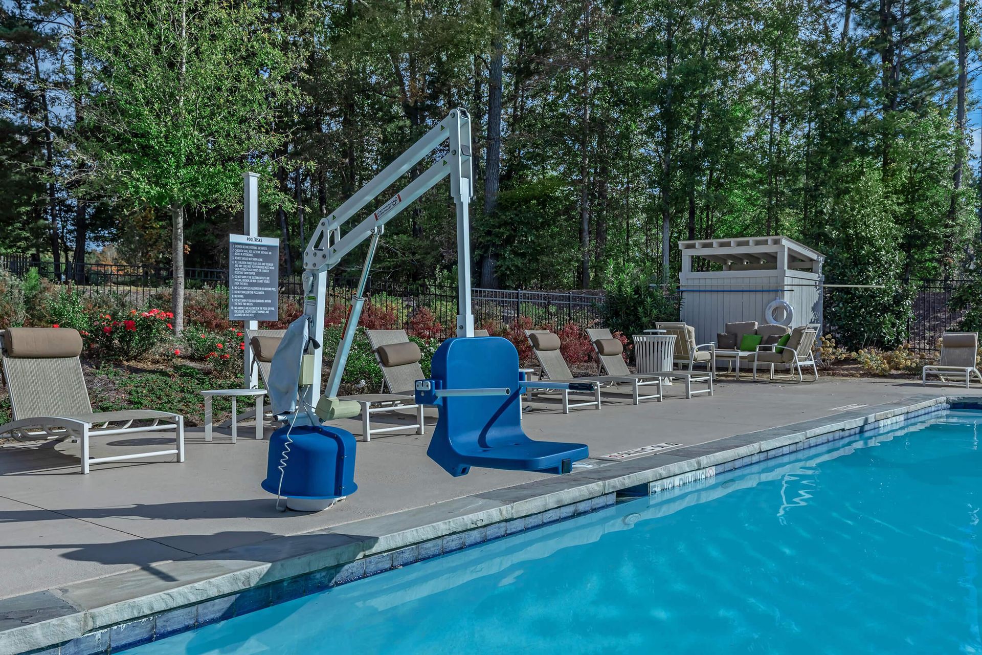 Blue pool lift at a swimming pool, for accessibility.