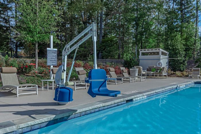 Blue pool lift at a swimming pool, for accessibility.