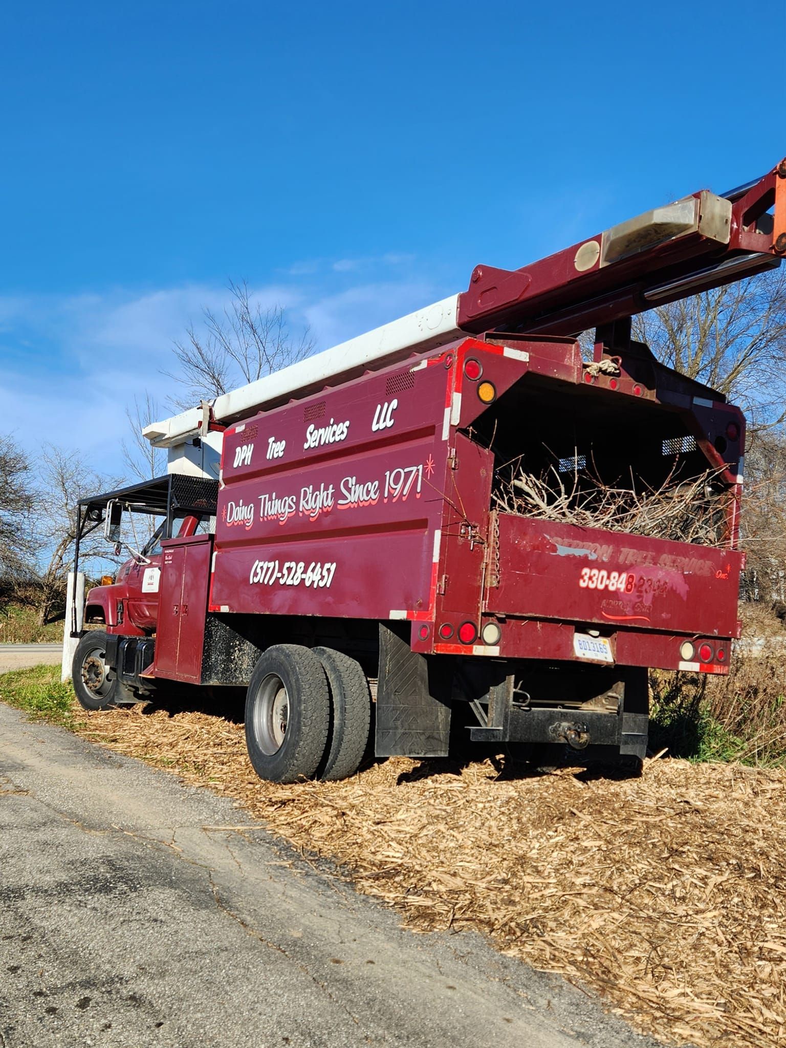 A red truck is parked on the side of a road.