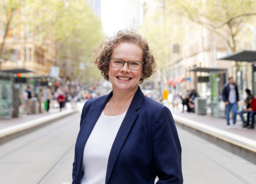 Genevieve Hawkins standing between two tram stations, Melbourne Victoria